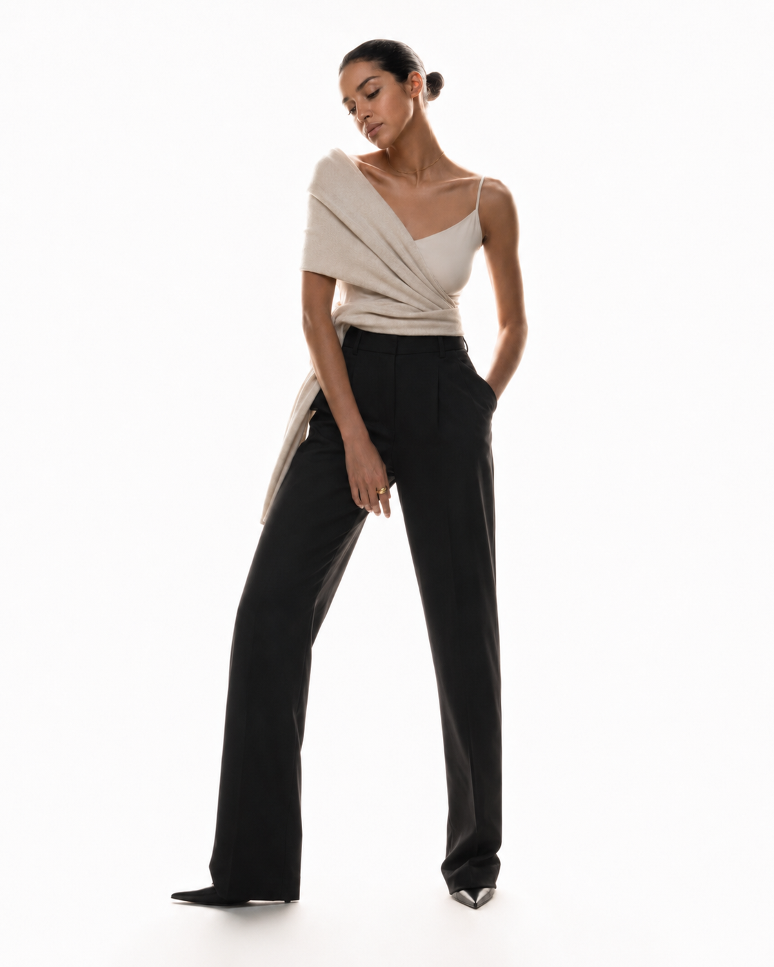 Model in an ivory wrap top and black trousers